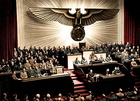 449px-Bundesarchiv_Bild_183-1987-0703-507_Berlin_Reichstagssitzung_Rede_Adolf_Hitler_color.jpg
